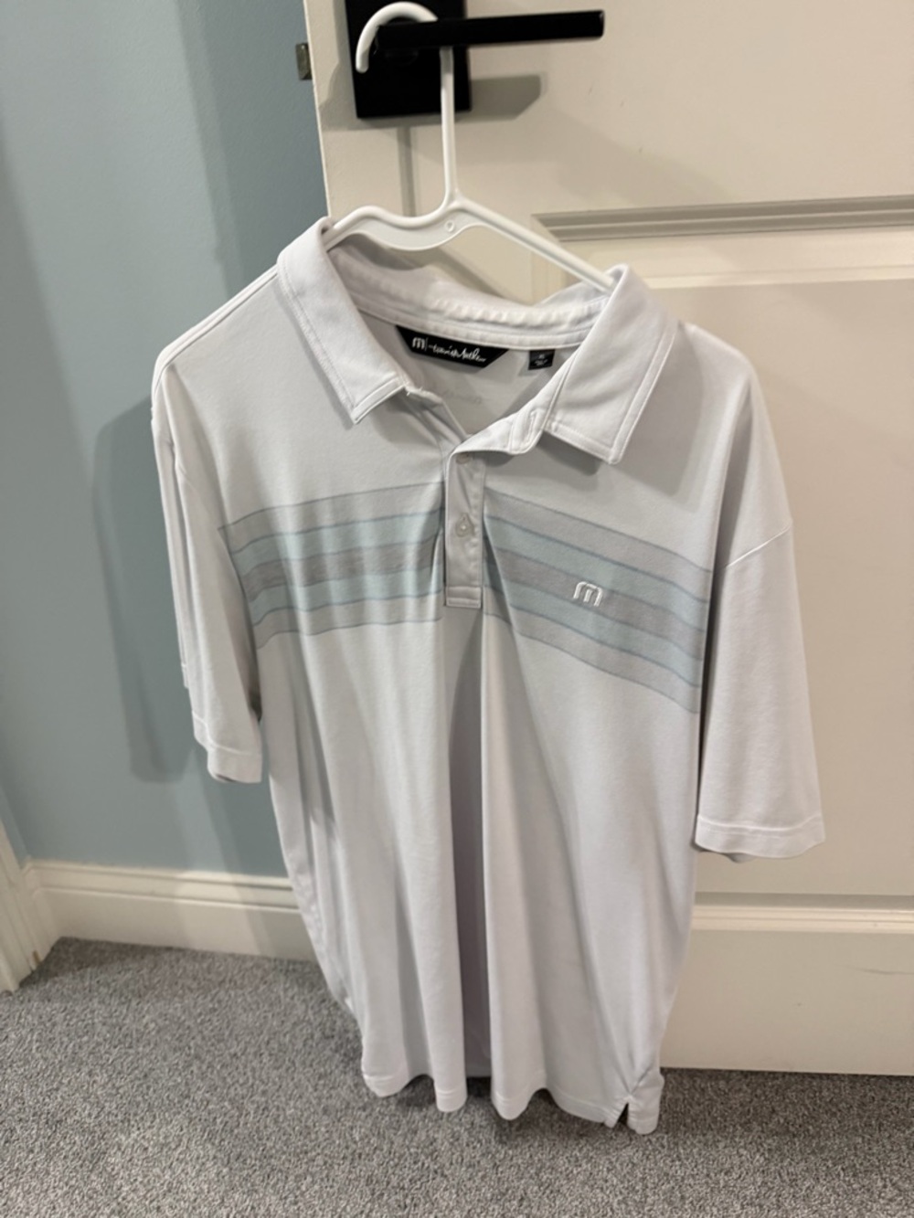 Travis Mathew White Polo with Light Gray-Blue Stripes